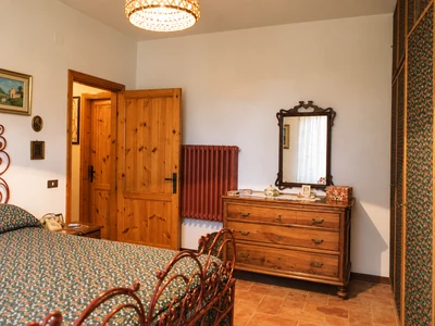 A welcoming bedroom with wooden furniture and floral fabrics